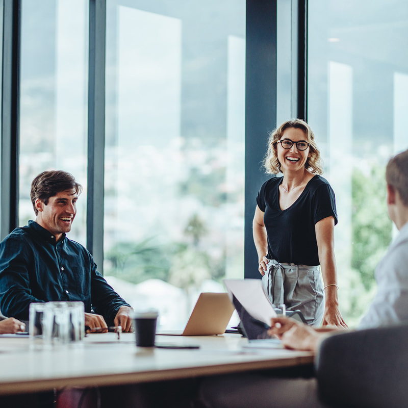 Group of young professionals in a meeting looking happy